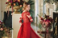 03 a red wedding gown with a lace illusion bodice and a plain layered skirt plus a high neckline and a rhinestone hairpiece