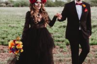 04 The groom was rocking a classic tux with a red bow and the bride was rocking a refined black lace dress