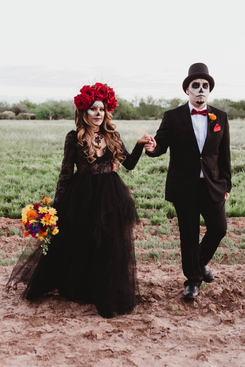 The groom was rocking a classic tux with a red bow and the bride was rocking a refined black lace dress