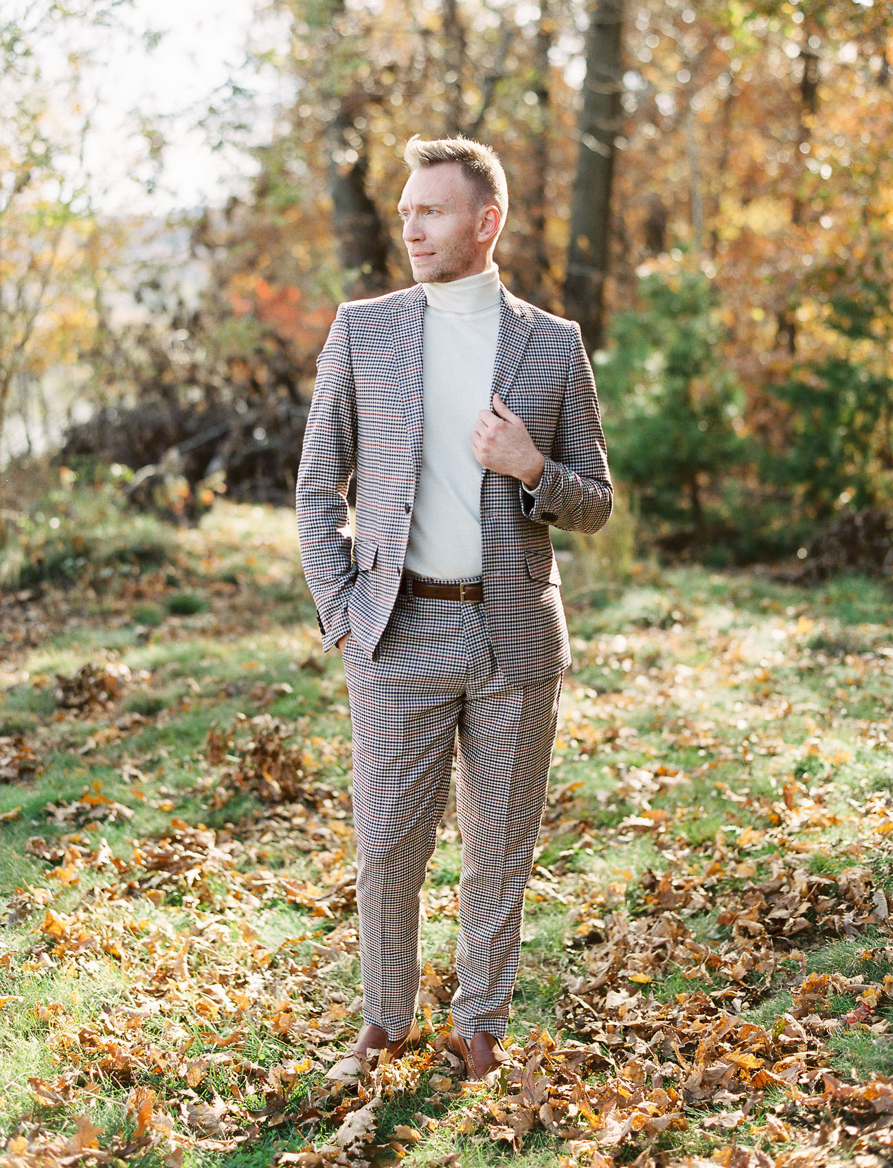 The groom was wearing a plaid suit, a neutral turtleneck and brown shoes