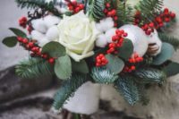 04 a Christmas wedding bouquet with holly berries, cotton, white roses and evergreens plus an ornament
