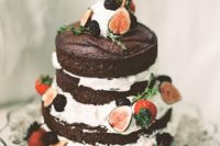 04 a naked chocolate wedding cake with blackberries, figs, straberries and much frosting looks super yummy