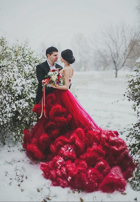 a jaw-dropping red strapless wedding gown with a super ruffled and long train is a bold statement at Christmas
