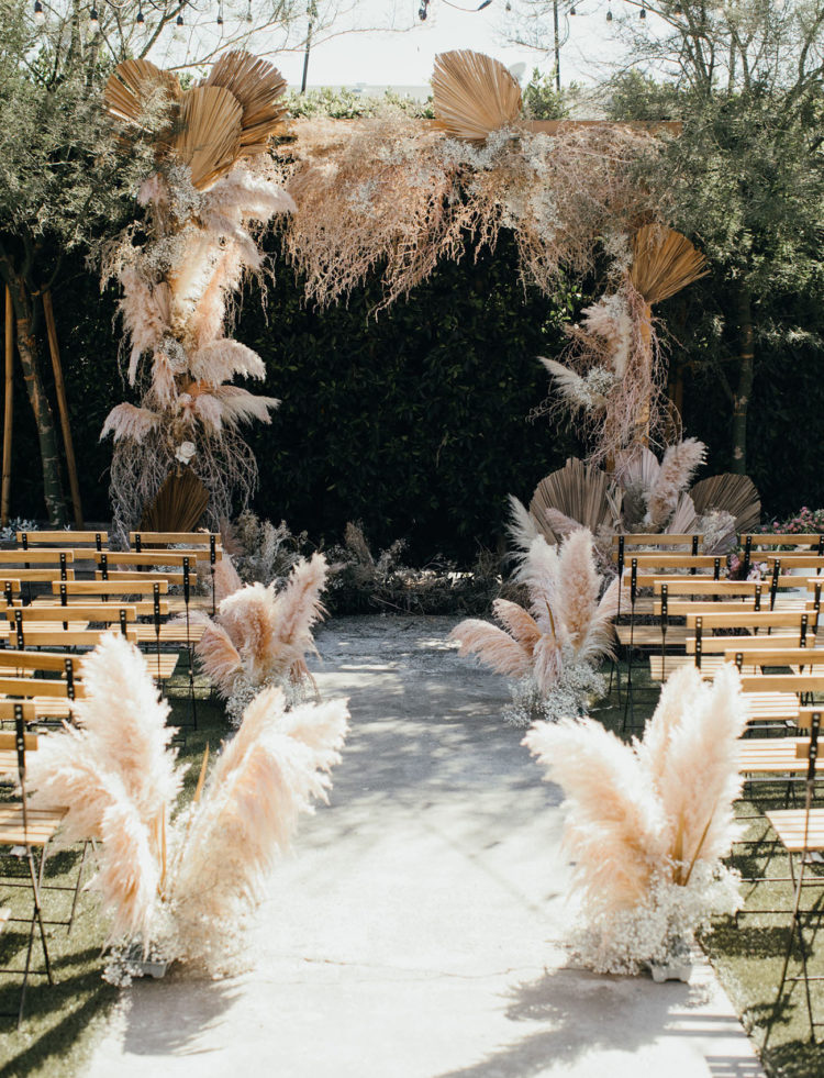 The wedding ceremony space was decorated with pampas grass, the arch was decorated with grasses and dried leaves