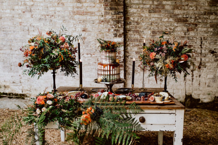 The wedding reception was done with lush florals, black candles and gold candle holders