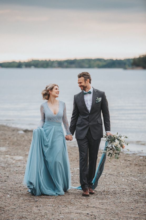 a winter Nordic bridal look with a blue wedding gown with a lace bodice and long sleeves, blue is a very trendy color for brides