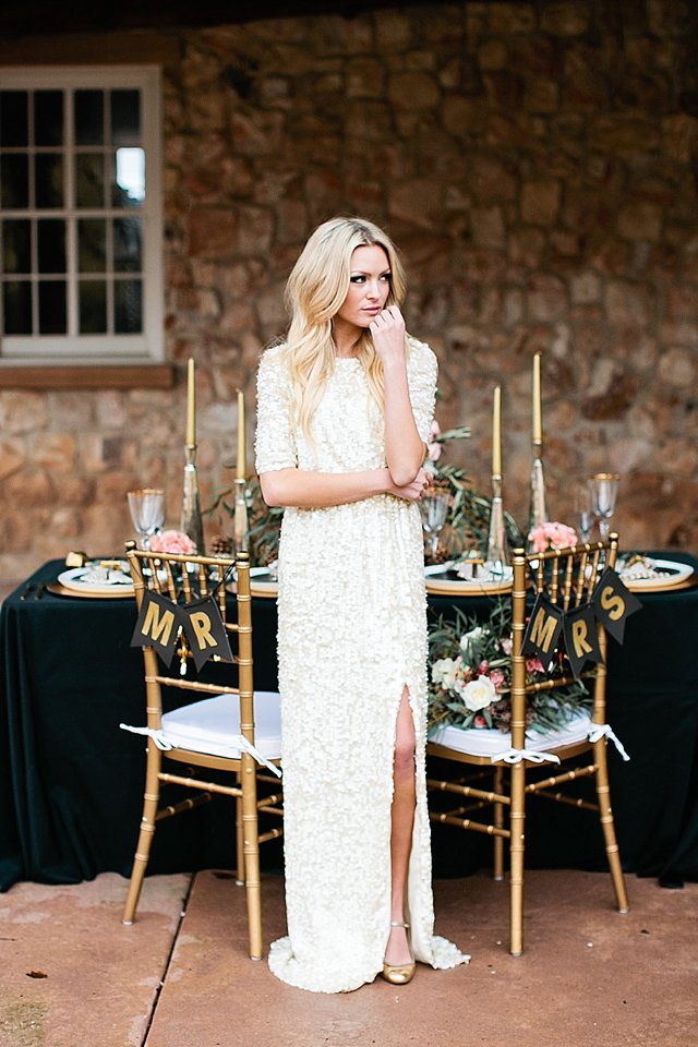 an ultra-modern wedding gown with long sleeves, a slit and with white sequins all over the dress