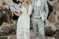 08 For the reception the bride was wearing a lace plunging neckline wedding gown and the groom was rocking a mint printed three-piece suit