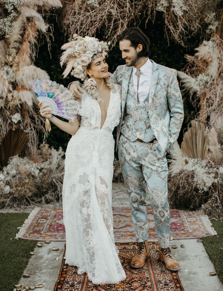 For the reception the bride was wearing a lace plunging neckline wedding gown and the groom was rocking a mint printed three-piece suit