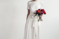 08 a modern wedding dress with a high neckline, short sleeves and a sash, no detailing at all