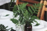 08 a simple centerpiece of pharmacy jars and greenery plus figs is great for a spring or summer woodland Scandi wedding
