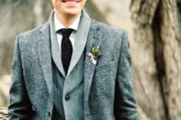 08 a winter groom look with a tweed jacket, a grey cardigan, a white shirt and a black tie for comfort and coziness