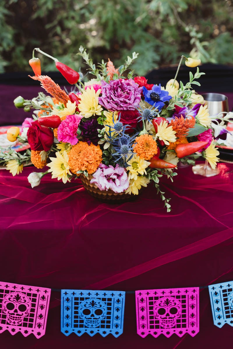 The wedding centerpiece was done with colorful blooms and hot peppers