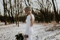 09 a minimalist fitting wedding gown with a high neckline and an open back for a modern winter Nordic look