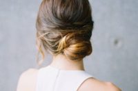 09 a modern low bun with a bump and locks down is a refined and elegant hairstyle for a minimalist bride