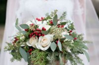 09 an effortlessly chic wedding bouquet with evergreens, foliage, holly berries and white roses