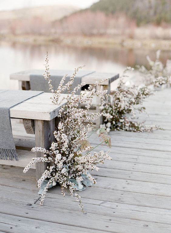 white blooms, whitewashed benches and grey covers create a real frozen look, which is very romantic for a winter wedding