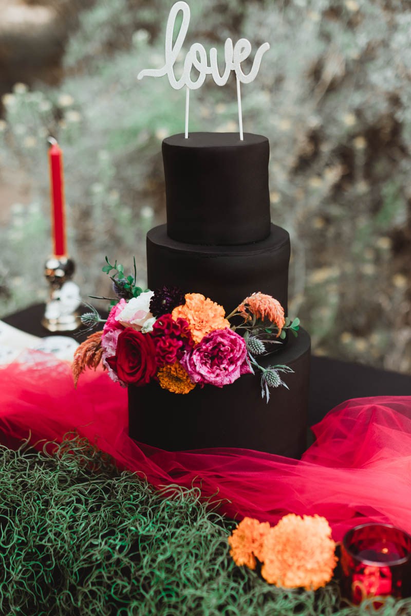 matte black wedding cake with flowers