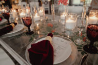 10 The wedding tables were styled with burgundy glasses and napkins, with candles and bright blooms