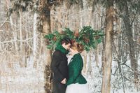 10 a creative wedding arch formed of two living trees and some evergreen branches attached to them plus pinecones and berries