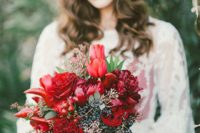 10 a winter wedding bouquet with red peonies and roses, chili peppers, and berries for Christmas
