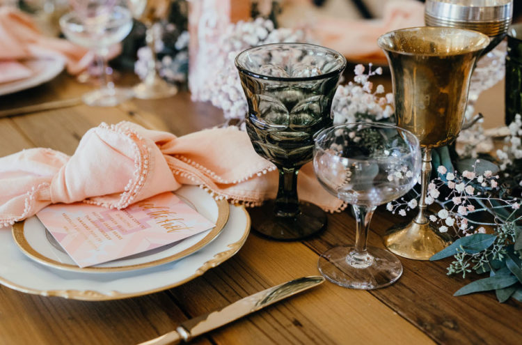 The gold golblets, colored glasses, baby's breath and pink pompom napkins added to the table settings