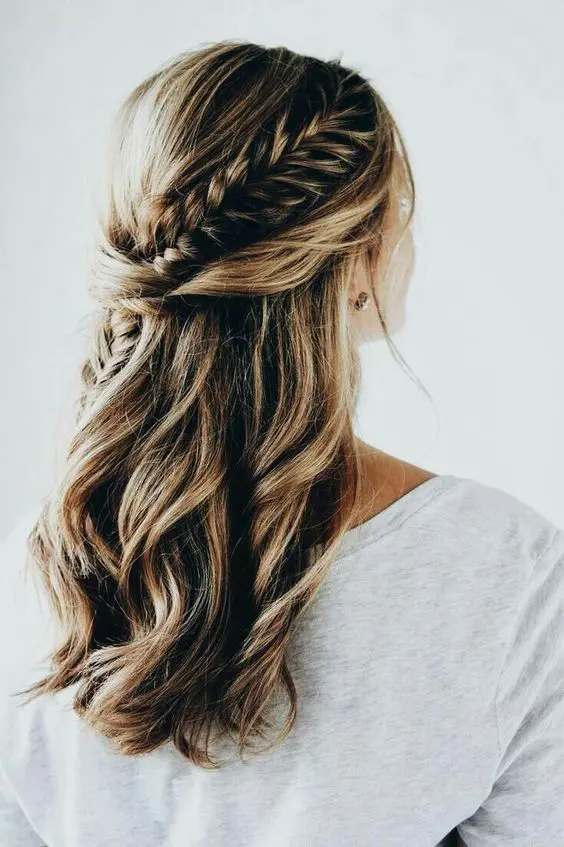 a boho chic wedding half updo with twists and a large French braid is a timeless boho chic option for any season