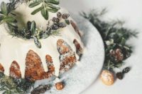 11 a bundt Christmas cake with dripping, evergreens, pinecones and nuts is a chic alternative to a usual winter wedding cake