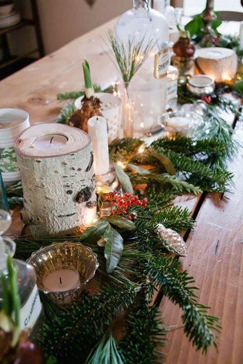 a cozy winter wedding table runner and centerpiece of evergreens, berries, candles, LEDs, birch branches and bulbs