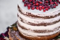 11 a naked wedding cake topped with fresh cranberry and a sugar deer is a gorgeous option for Christmas