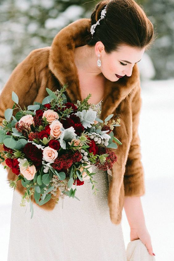 a winter wedding bouquet of burgundy, red and blush blooms plus pale greenery and eucalyptus