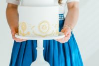 12 The wedding cake was a white one decorated with yellow patterns with a folksy feel
