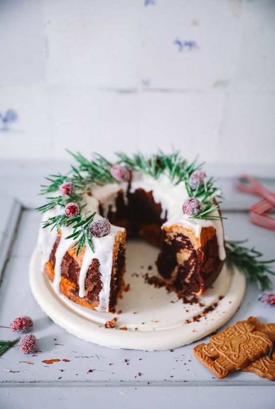 a bundt wedding cake with dripping, sugared cranberries, evergreens for a winter or Christmas wedding