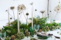 12 a woodland style wedding centerpiece of greenery, succulents, dired blooms and pinecones for a Nordic woodland summer or fall wedding