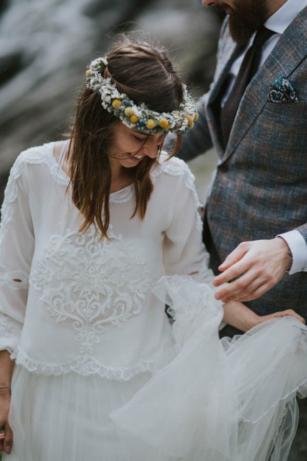 a boho bridal look with a layered tulle skirt and a top with long sleeves, lace trim and patterns