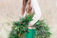 13 a large and lush evergreen wedding wreath with berries and foliage is a cool decoration for a winter Scandinavian wedding
