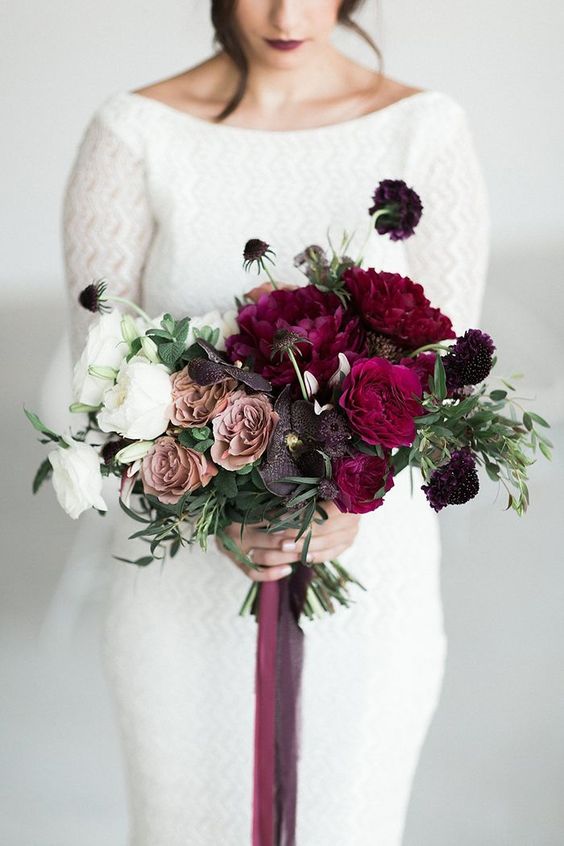 a super bold ombre wedding bouquet with white, dusty pink, deep purple and crimson blooms for a winter bride