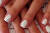 14 white nails with a touch of glitter on top and white ones with silver stripes to sparkle all over