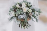 16 a grey and cream wedding bouquet with pale succulents, evergreens and pinecones for winter