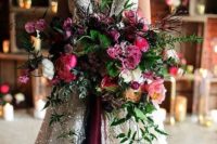 16 a super lush and refined wedding bouquet in the shades of pink, burgundy, orange, with berries and greenery of various kinds