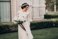 17 a modest wedding dress with a lace bodice with three quarter sleeves and a layered flowy skirt