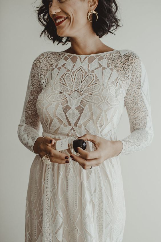 a chic boho inspired geometric wedding gown with a fitting silhouette, long sleeves and a high neckline