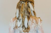 18 a half updo with a bump and waves spruced up with a lot of feathers is inspired by vikings and is ideal for a boho bride