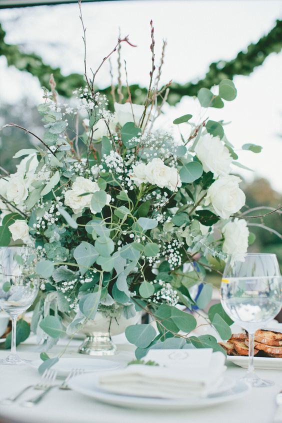 a lush greenery and white peony and baby's breath wedding centerpiece is amazing for spring or summer weddings