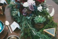 19 a lush Nordic wedding centerpiece of bold blooms, evergreens, succulents, antlers and geometric candle lanterns