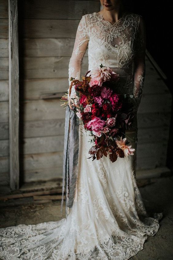 a romantic lace wedding dress with an illusion neckline and long sleeves plus s train for Christmas
