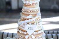 20 a beautiful kransekake wedding cake decorated with ribbons and creamy touches is a traditional Nordic idea