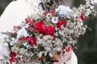 20 a frozen Christmas wedding bouquet with red and white blooms, pale greenery and holly berries