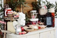 21 a cozy vintage hot cocoa bar made with a sideboard, decorated with evergreens and plaids