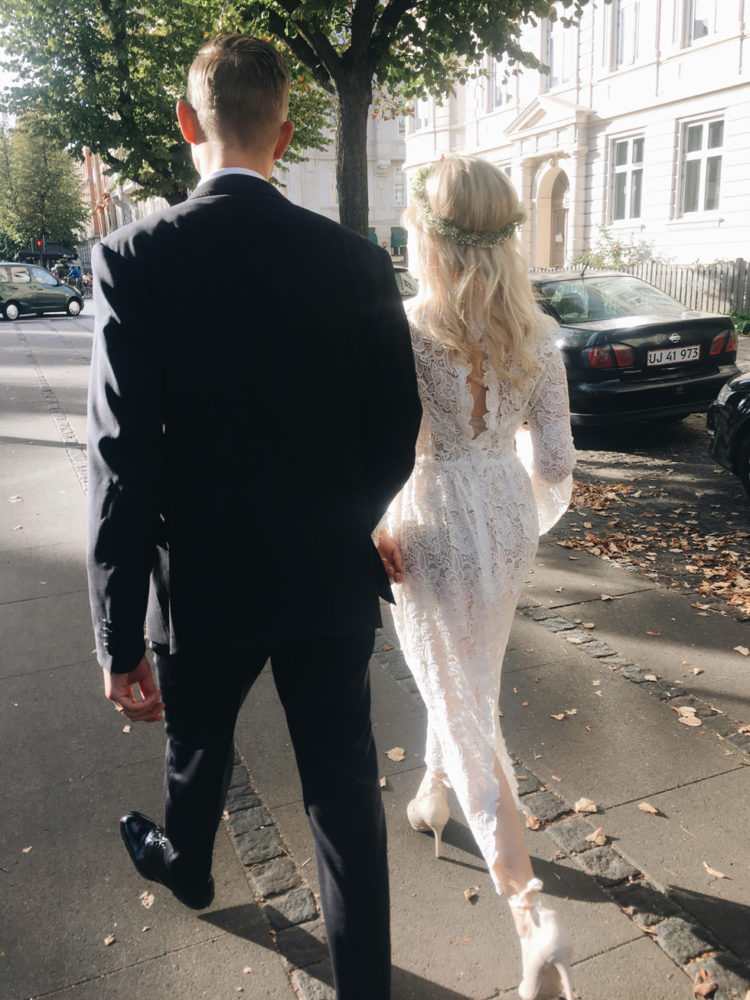 a midi boho lace fitting wedding dress with a slit on the back, long sleeves and a cutout